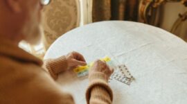 Seorang pasien sedang memelajari lembaran petunjuk dan efek samping obat sebelum mengonsumsi sediaan farmasi. Sikap teliti dalam membaca aturan pakai menjadi langkah awal mencegah reaksi sekunder yang tidak diinginkan pada tubuh.